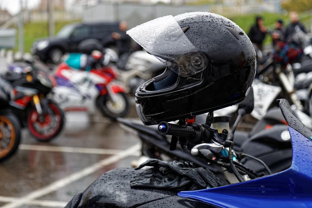 image of a bunch of parked motorcycles with raindrops on them