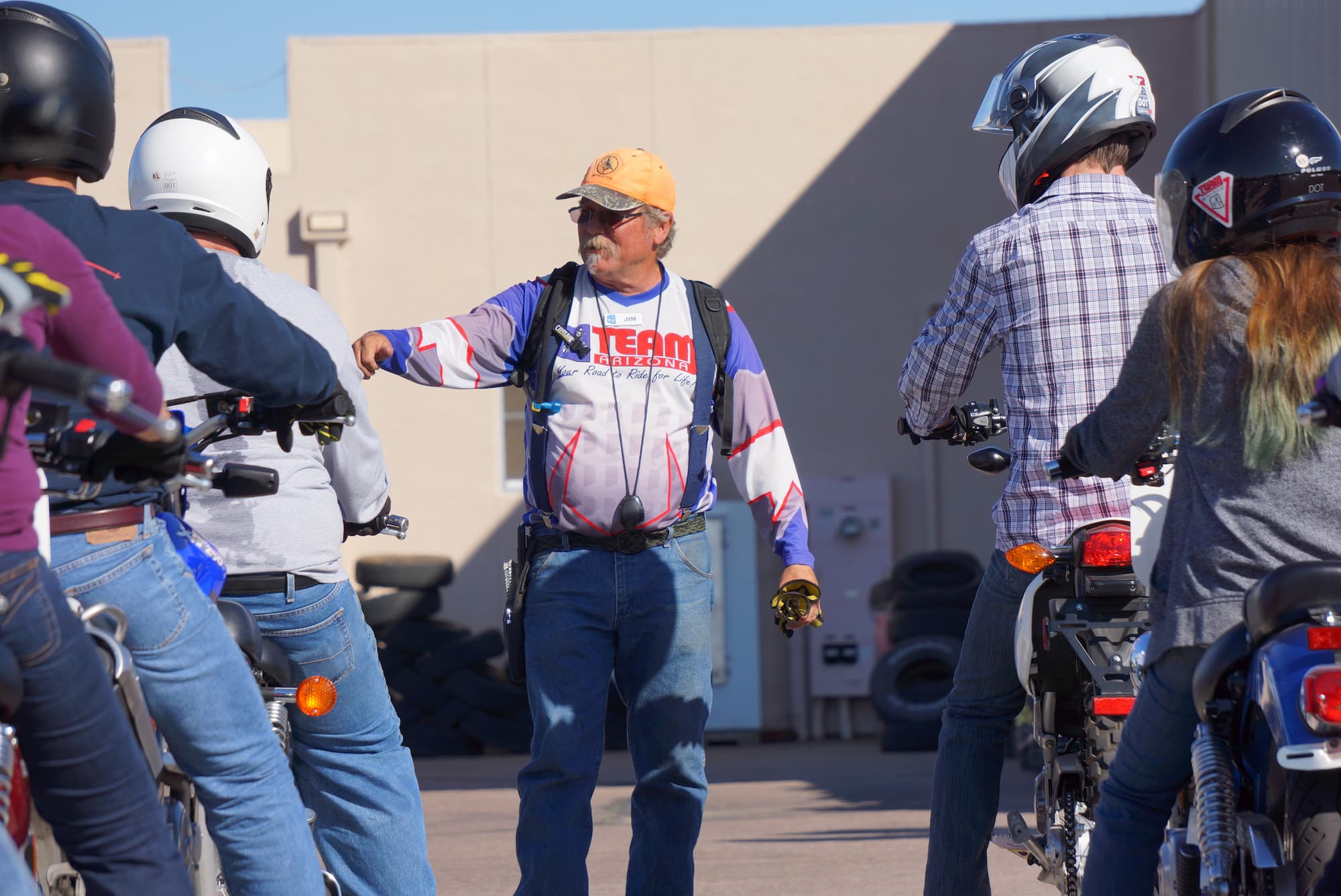 a team arizona motorcyle instructor teaching students on motorcycles how to ride